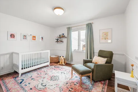 a bedroom with furniture and wooden floor