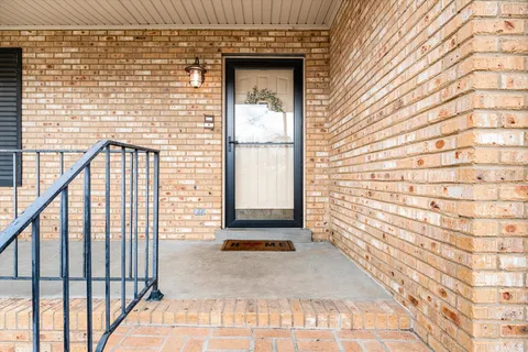 a view of front door of house with stairs