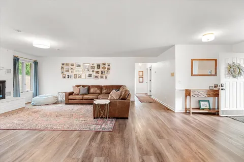 a living room with furniture and a wooden floor