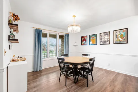 a view of a dining room with furniture wooden floor and chandelier