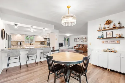 a view of kitchen with stainless steel appliances granite countertop cabinets and wooden floor