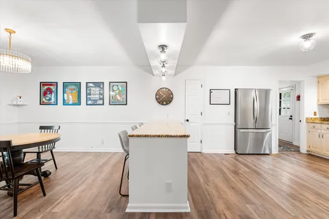 a kitchen with granite countertop white cabinets and white appliances