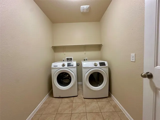 a front view of house with yard and trees in the background