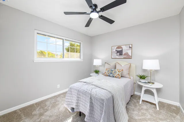 a bedroom with a bed and a lamp on table