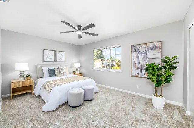a bedroom with a bed and a potted plant