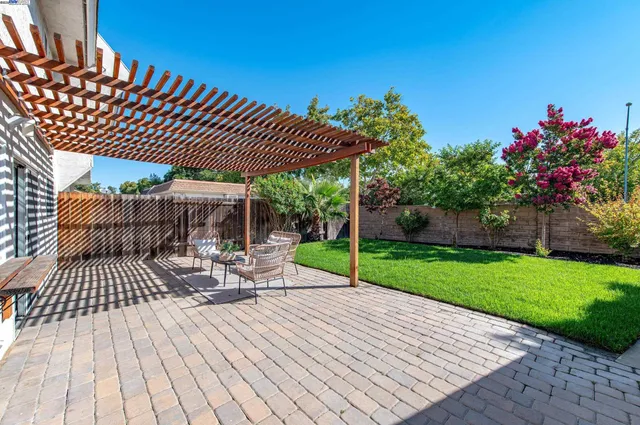 a view of a patio with a table and chairs