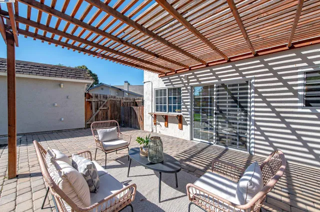a view of small house with wooden fence