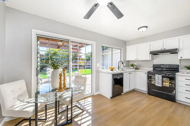 a kitchen with a stove a sink and a refrigerator
