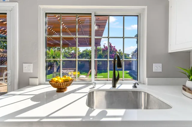 a view of a kitchen with a large window and a potted plant