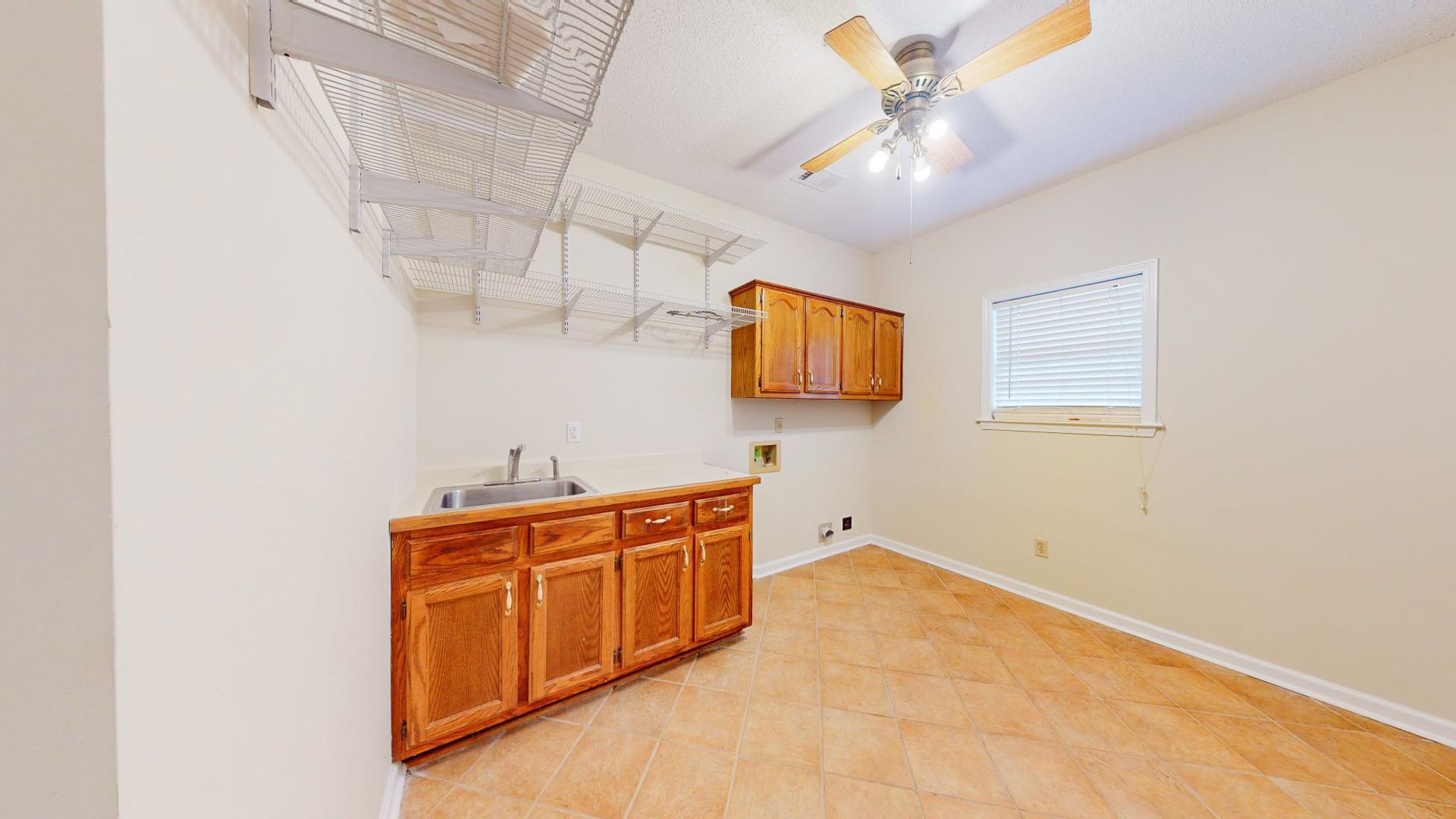 5086 Fleming Road Collierville, TN 38017 - Photo 21 of 25 Kitchen featuring light tile patterned floors, sink, and ceiling fan