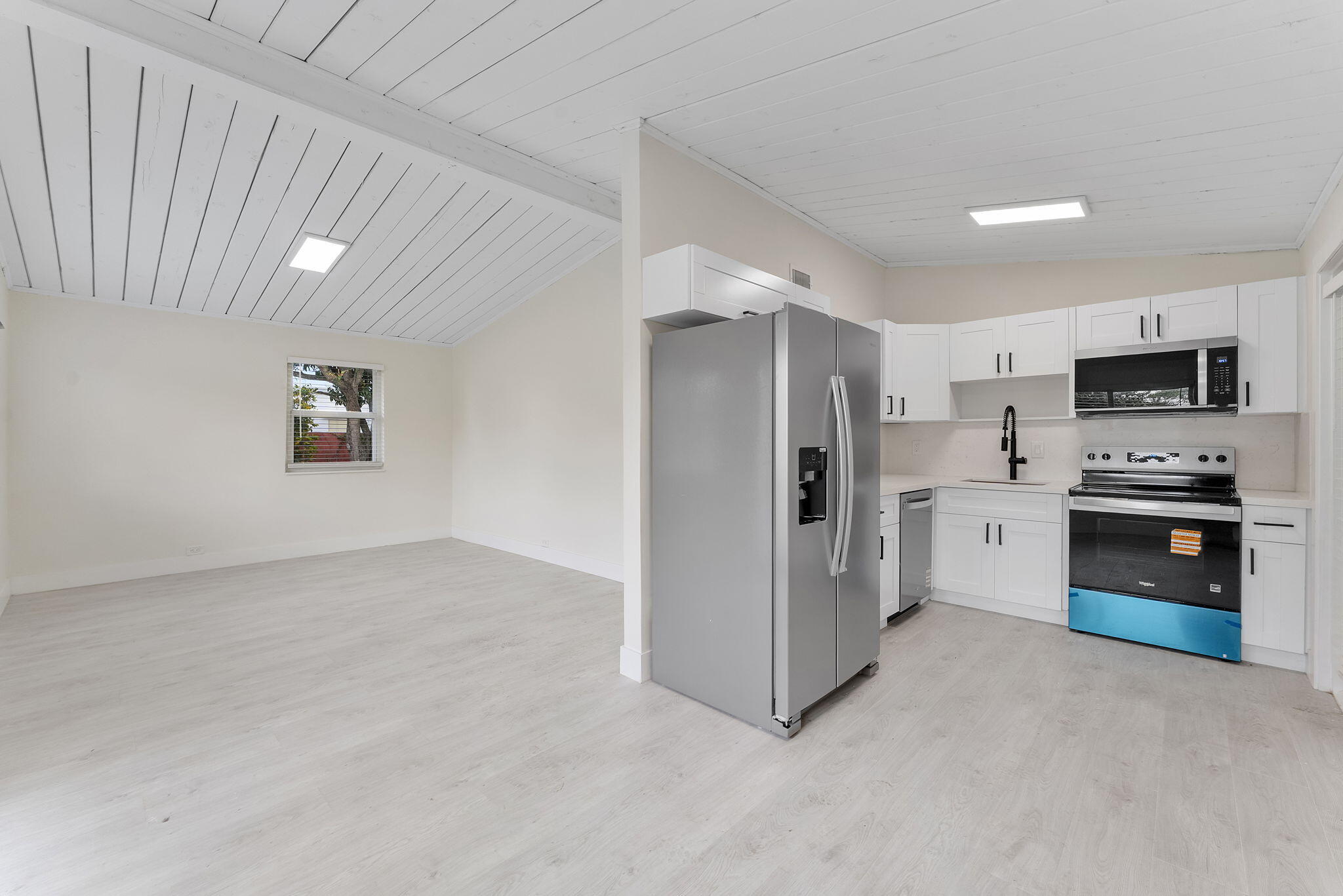 474 Enfield Street Boca Raton, FL 33487 - Photo 17 of 40 a kitchen with a refrigerator and a stove top oven