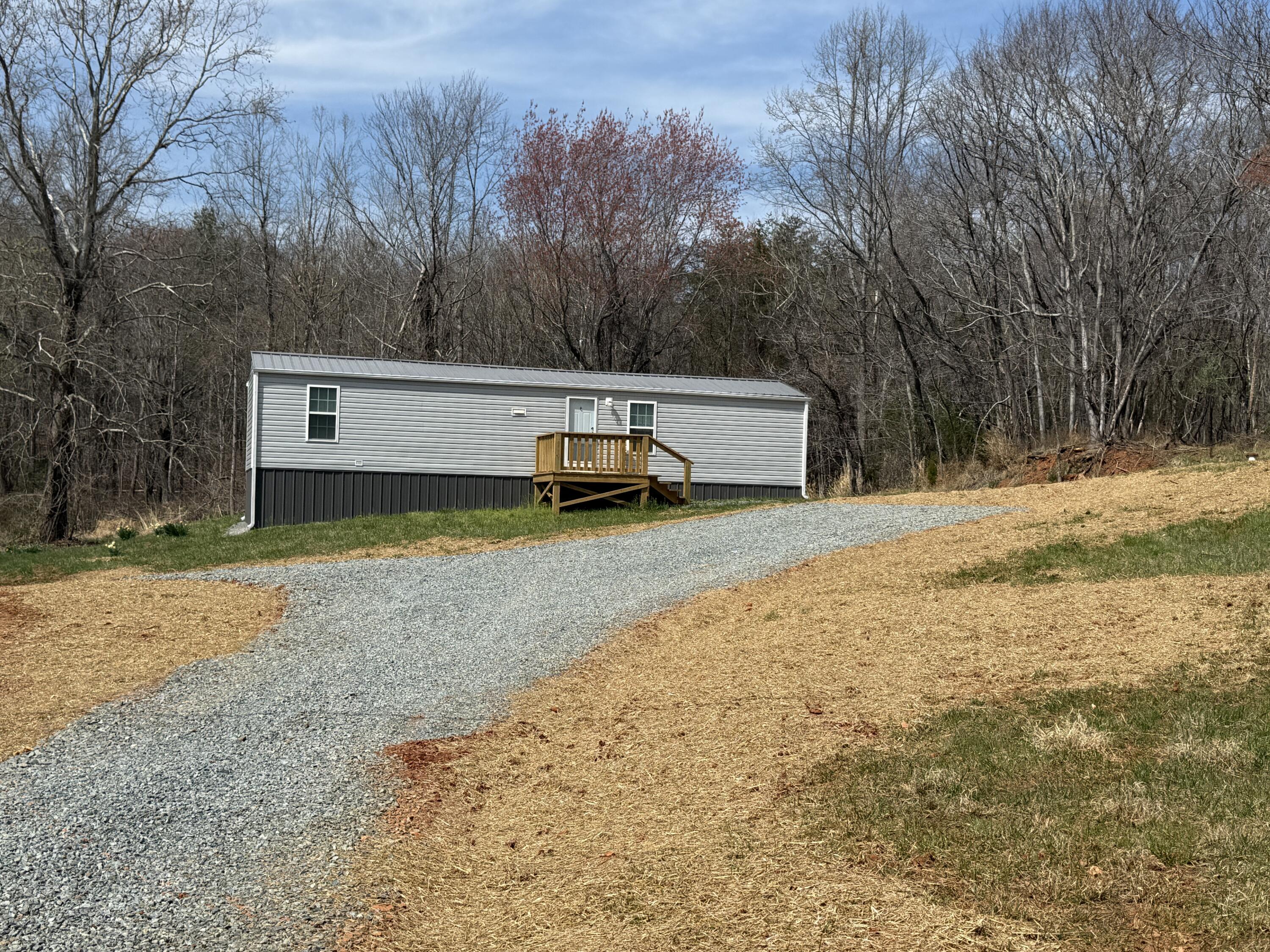 268 Briar Mountain Road Rocky Mount, VA 24151 - Photo 11 of 11 a view of a backyard with large trees