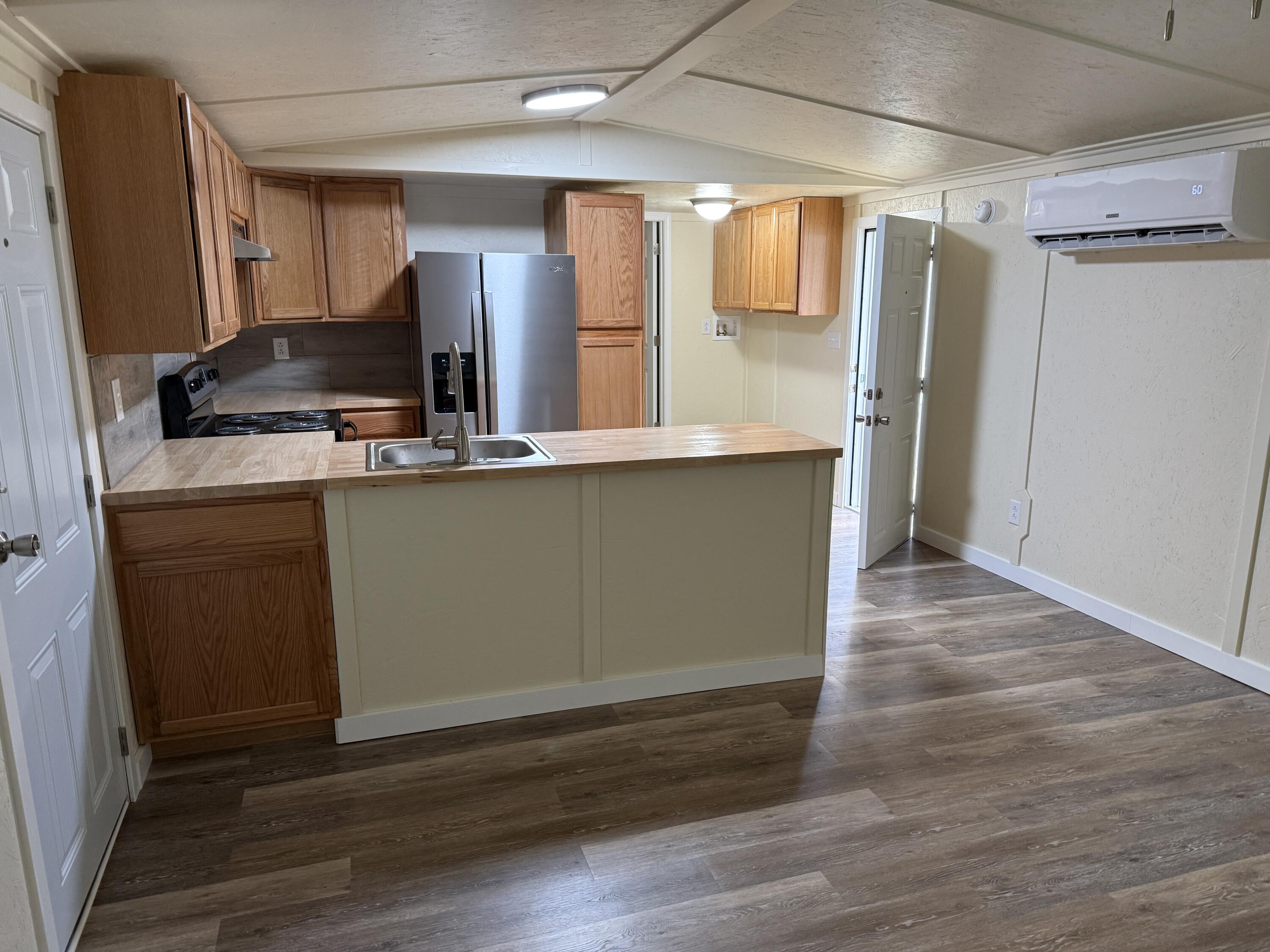 268 Briar Mountain Road Rocky Mount, VA 24151 - Photo 2 of 11 a kitchen with stainless steel appliances granite countertop a sink and wooden cabinets