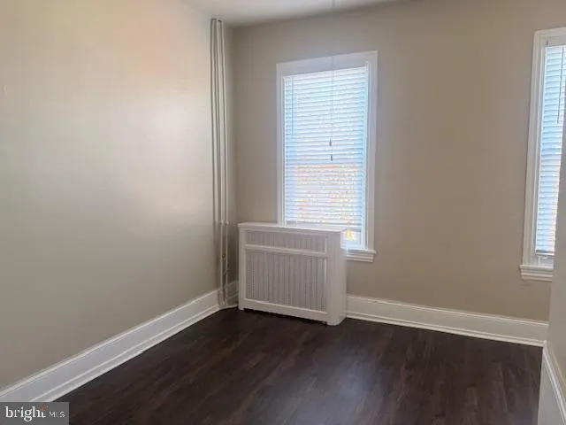 an empty room with a closet and a window