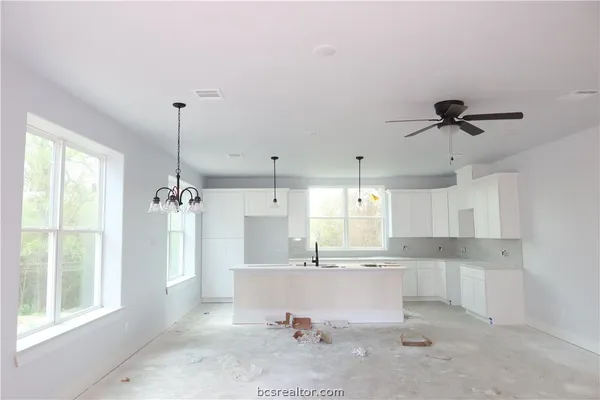 a view of a kitchen with a sink stainless steel appliances and cabinets