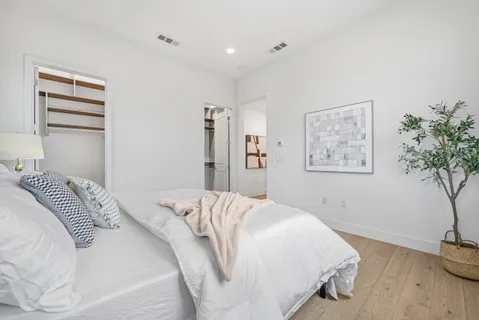 a bedroom with a bed and a chandelier