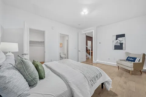 a bedroom with a bed and a couch