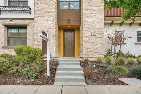 a front view of a house with a garden
