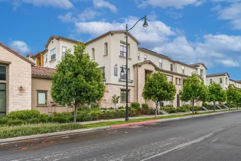 a view of a brick building next to a yard