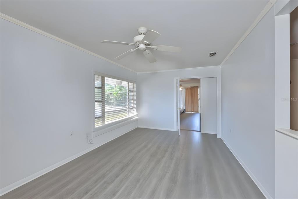 14451 Highland Road Wimauma, FL 33598 - Photo 57 of 80 a view of empty room with wooden floor and fan