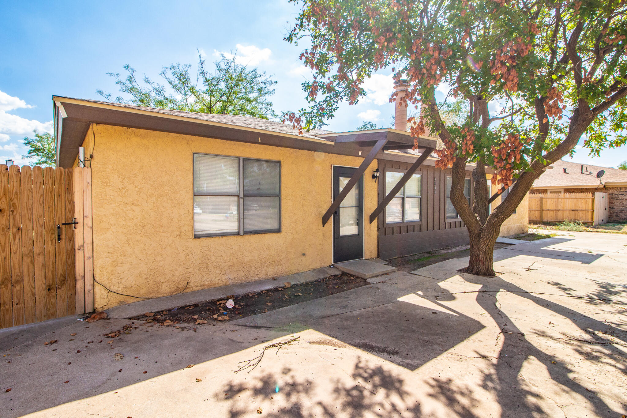 6103 38th Street, Unit B Lubbock, TX 79407 - Photo 2 of 11 a view of a yard with a tree