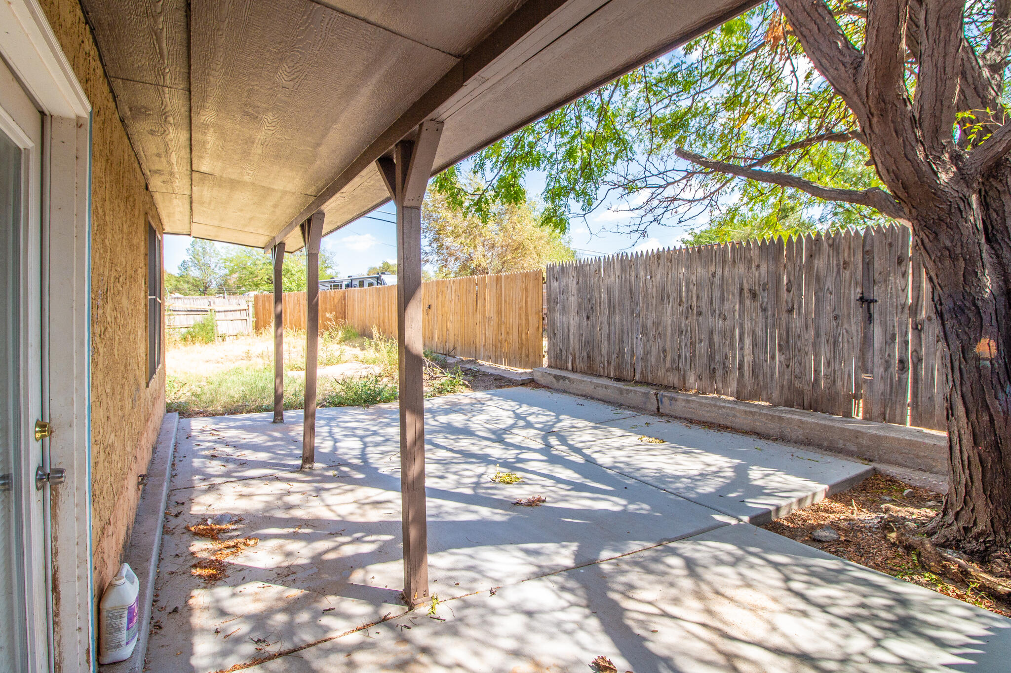 6103 38th Street, Unit B Lubbock, TX 79407 - Photo 10 of 11 a view of a backyard with floor to ceiling window and wooden fence