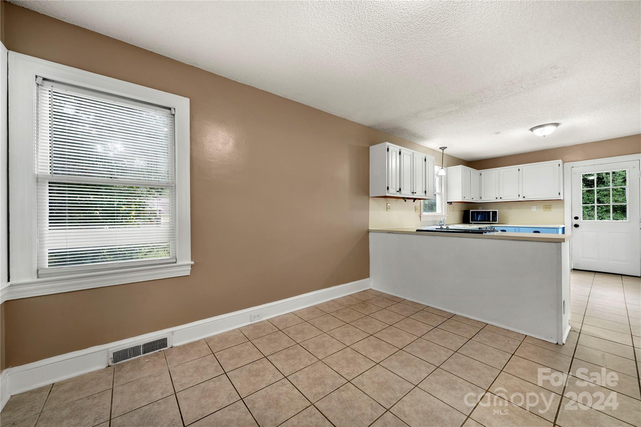 8101 Plott Road Charlotte, NC 28215 - Photo 12 of 34 a kitchen with cabinets and window