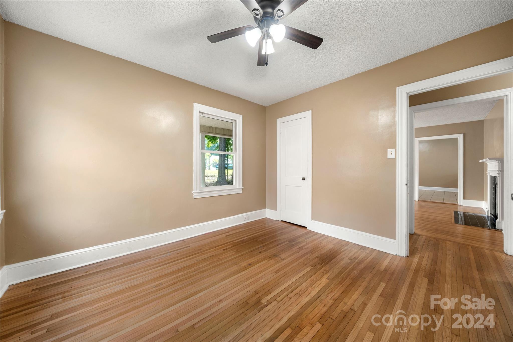 8101 Plott Road Charlotte, NC 28215 - Photo 18 of 34 a view of an empty room with window and wooden floor