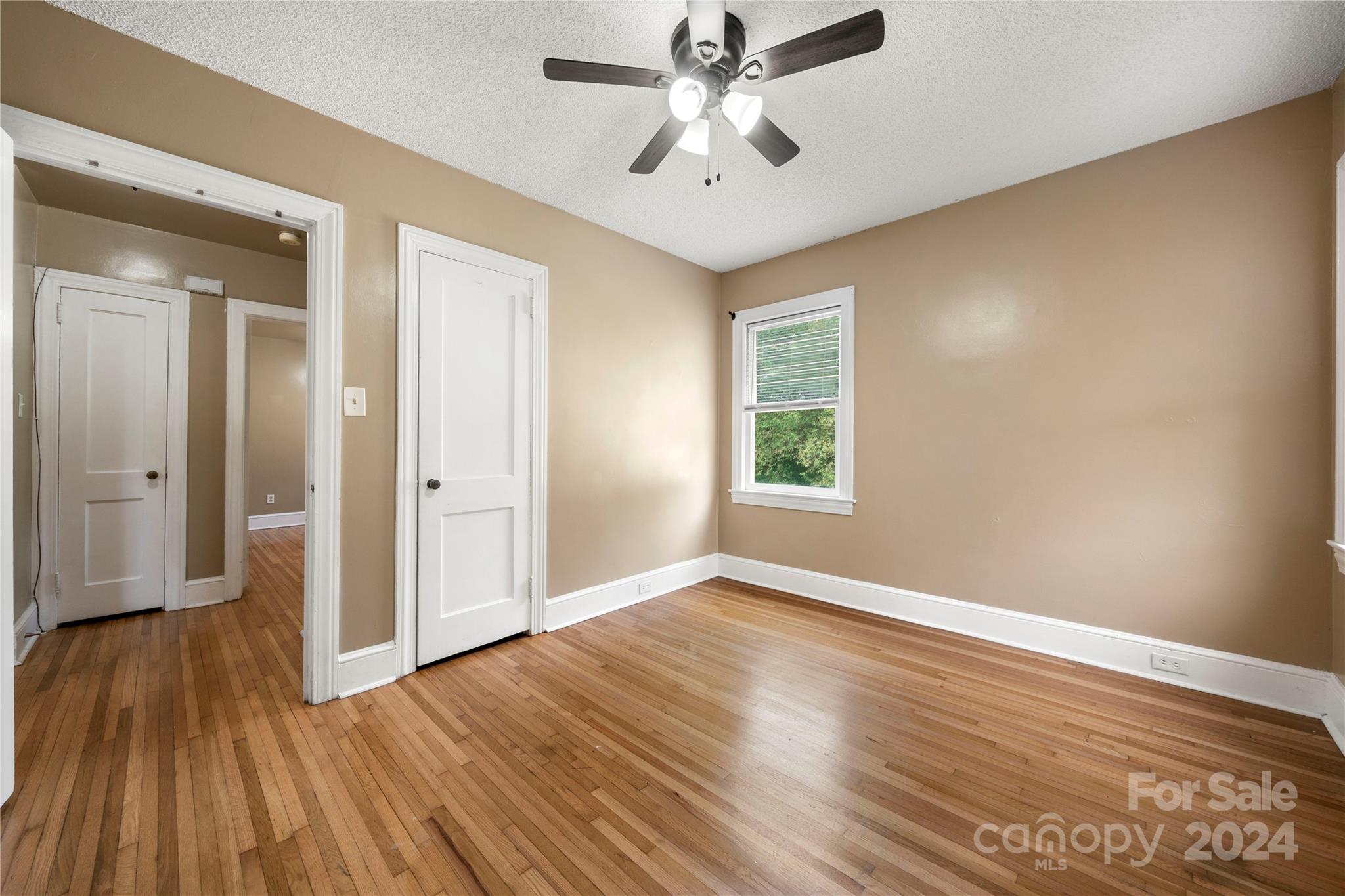 8101 Plott Road Charlotte, NC 28215 - Photo 23 of 34 a view of empty room with wooden floor and fan