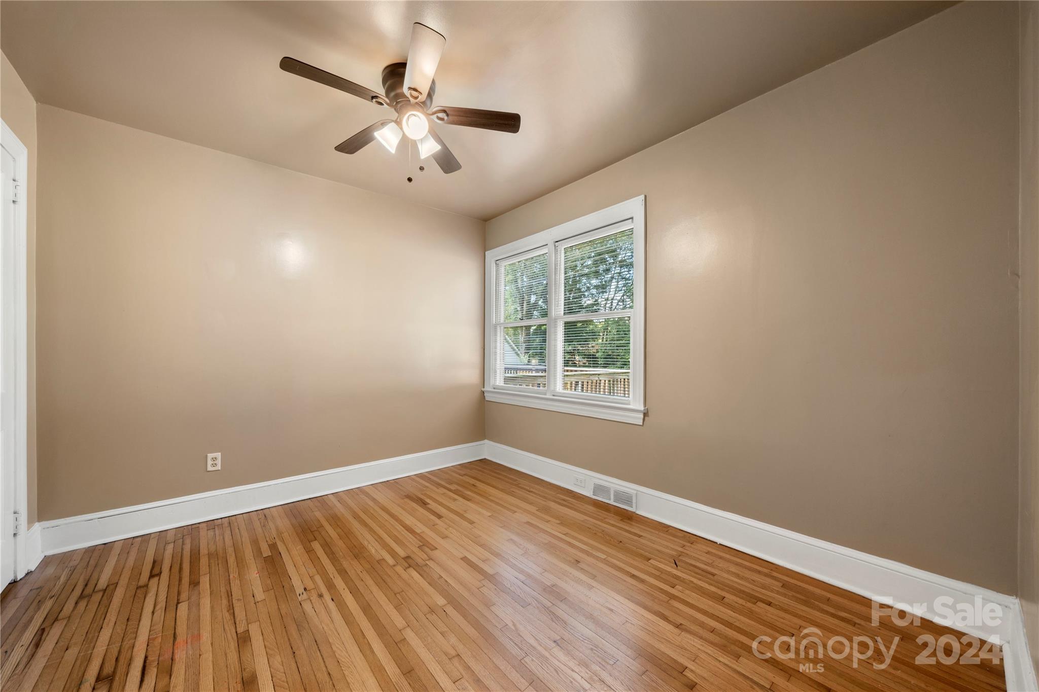 8101 Plott Road Charlotte, NC 28215 - Photo 24 of 34 wooden floor in an empty room with a window