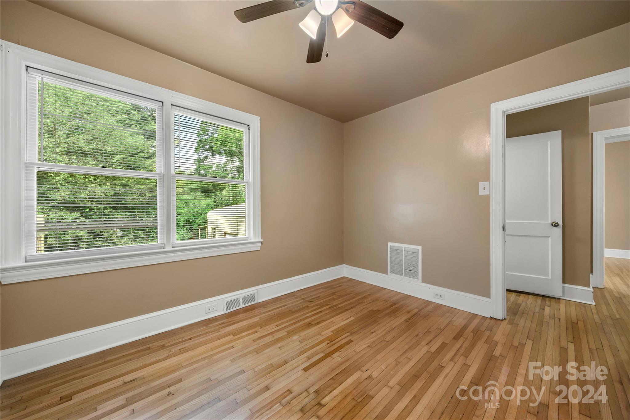 8101 Plott Road Charlotte, NC 28215 - Photo 25 of 34 a view of empty room with wooden floor and fan