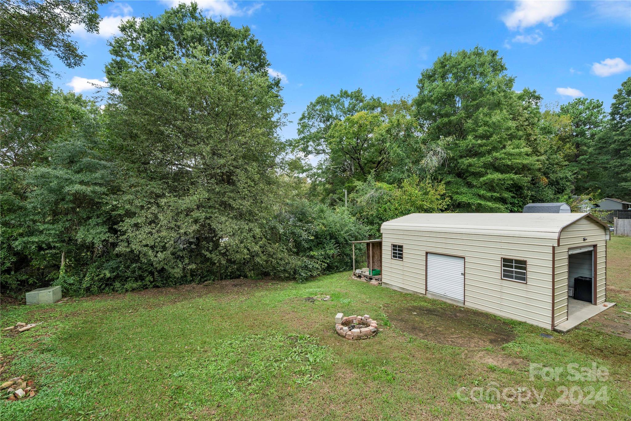 8101 Plott Road Charlotte, NC 28215 - Photo 31 of 34 a view of a white house with a yard