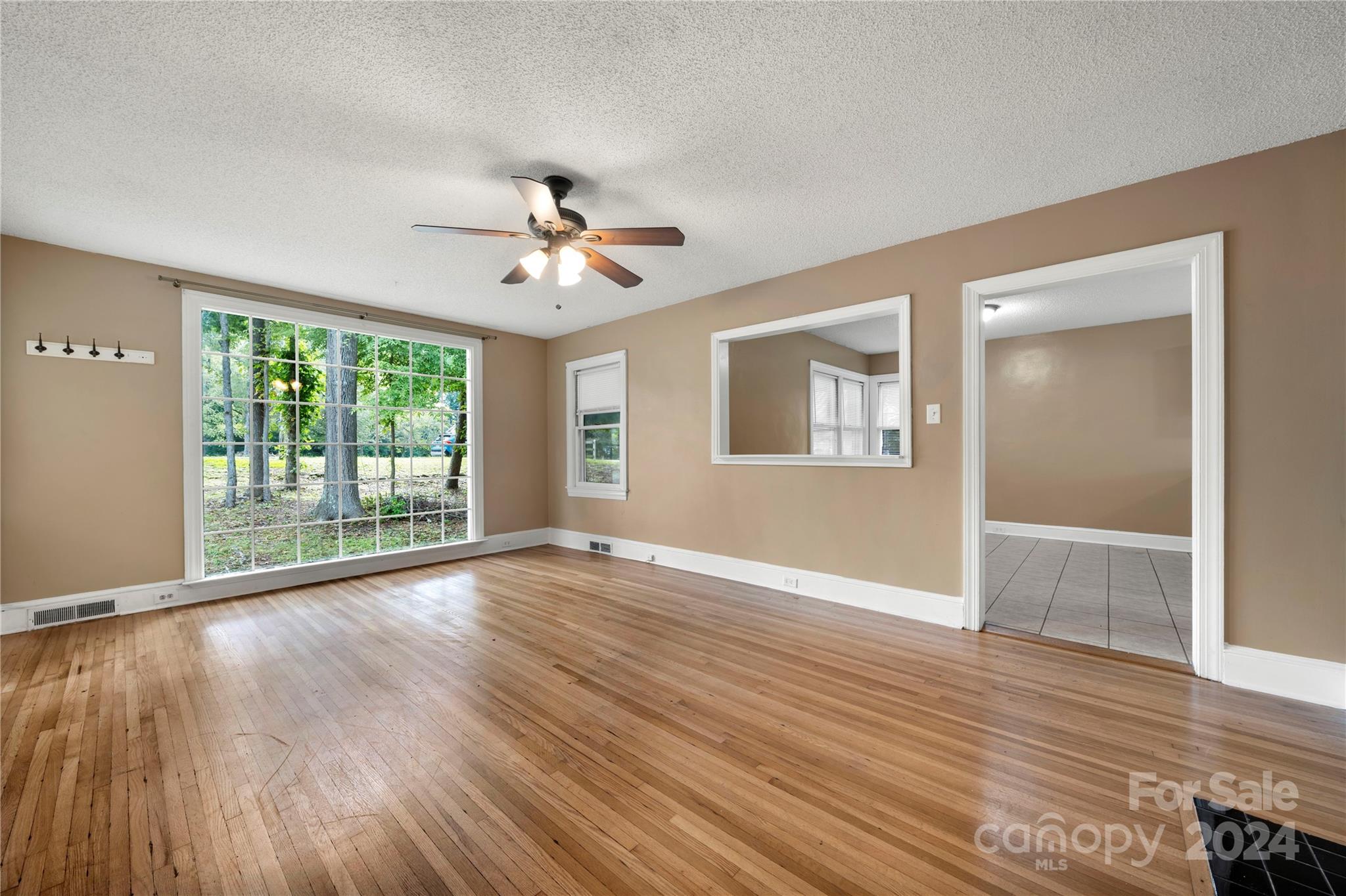 8101 Plott Road Charlotte, NC 28215 - Photo 8 of 34 a view of an empty room with wooden floor and a window