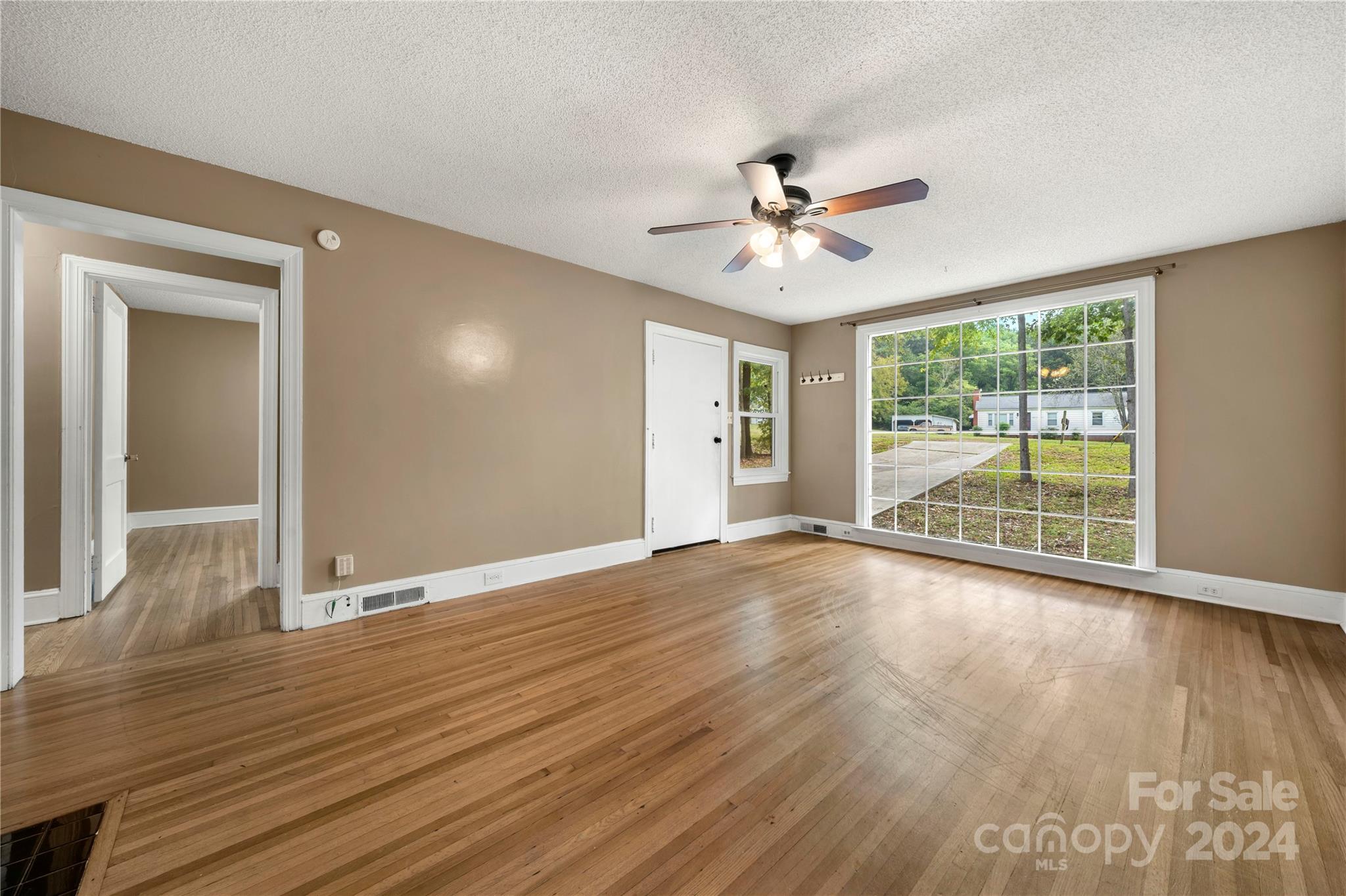 8101 Plott Road Charlotte, NC 28215 - Photo 9 of 34 a view of an empty room with wooden floor and a window