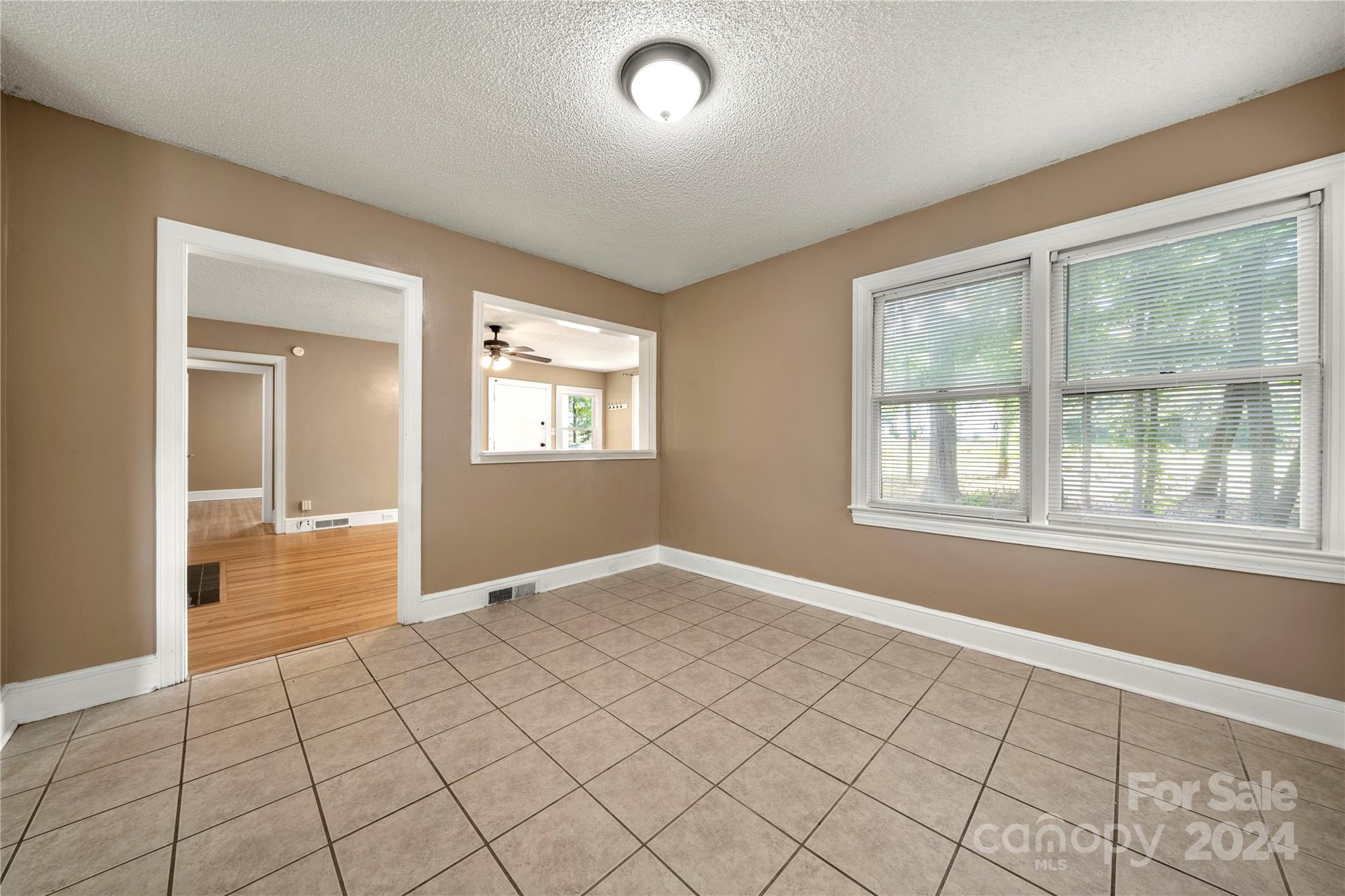 8101 Plott Road Charlotte, NC 28215 - Photo 10 of 34 a view of an empty room with window and chandelier fan
