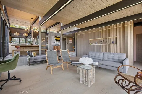 a living room with furniture and floor to ceiling windows