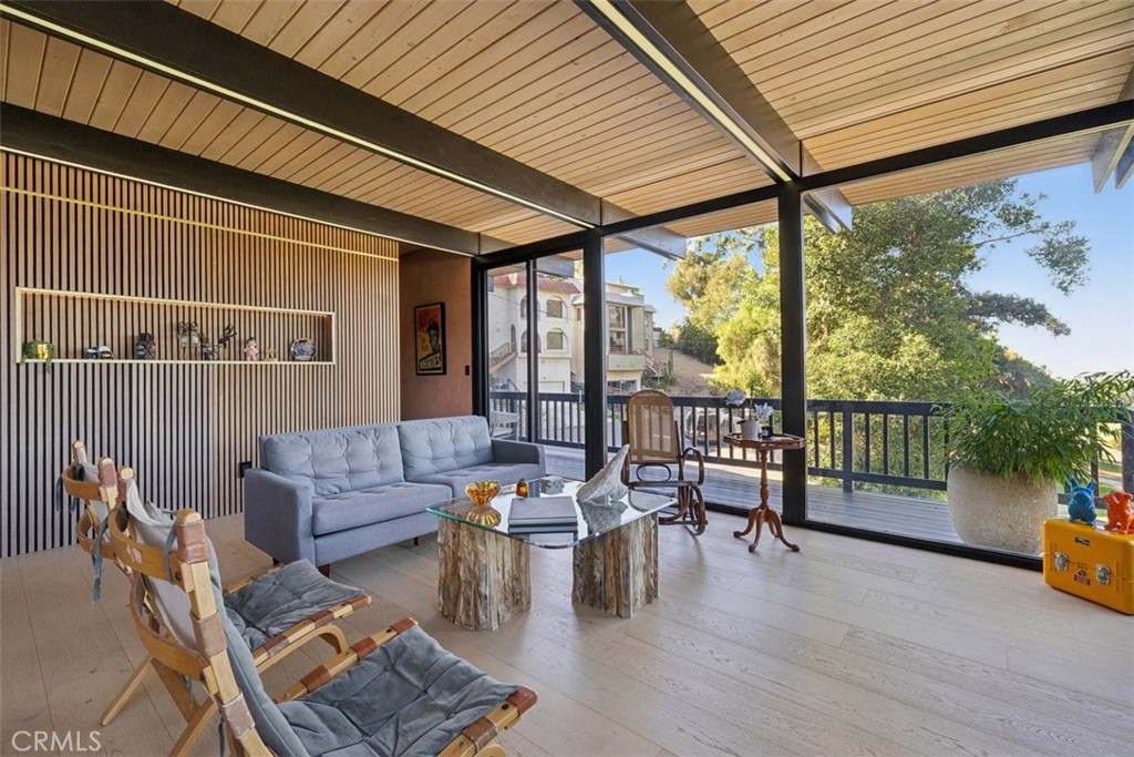 21090 Rios Street Woodland Hills, CA 91364 - Photo 14 of 61 a living room with furniture and a floor to ceiling window