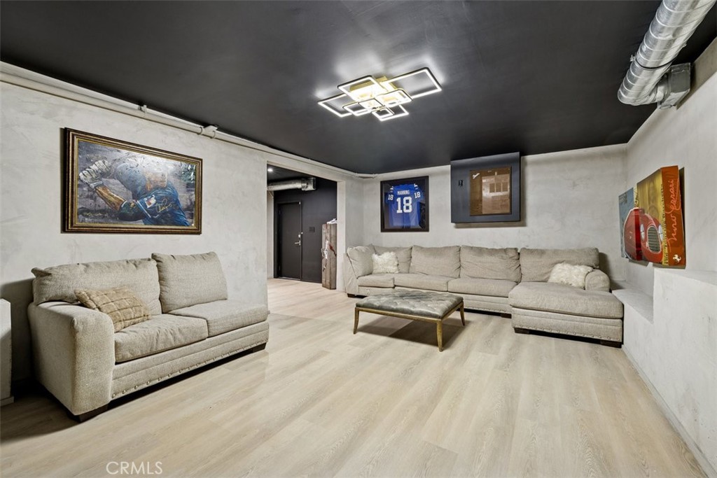 21090 Rios Street Woodland Hills, CA 91364 - Photo 37 of 61 a living room with furniture and a chandelier
