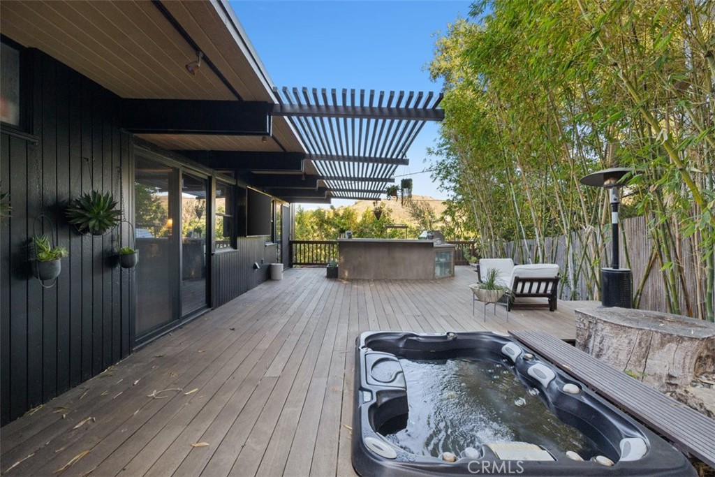 21090 Rios Street Woodland Hills, CA 91364 - Photo 39 of 61 a view of a porch with couches table and chairs and wooden floor