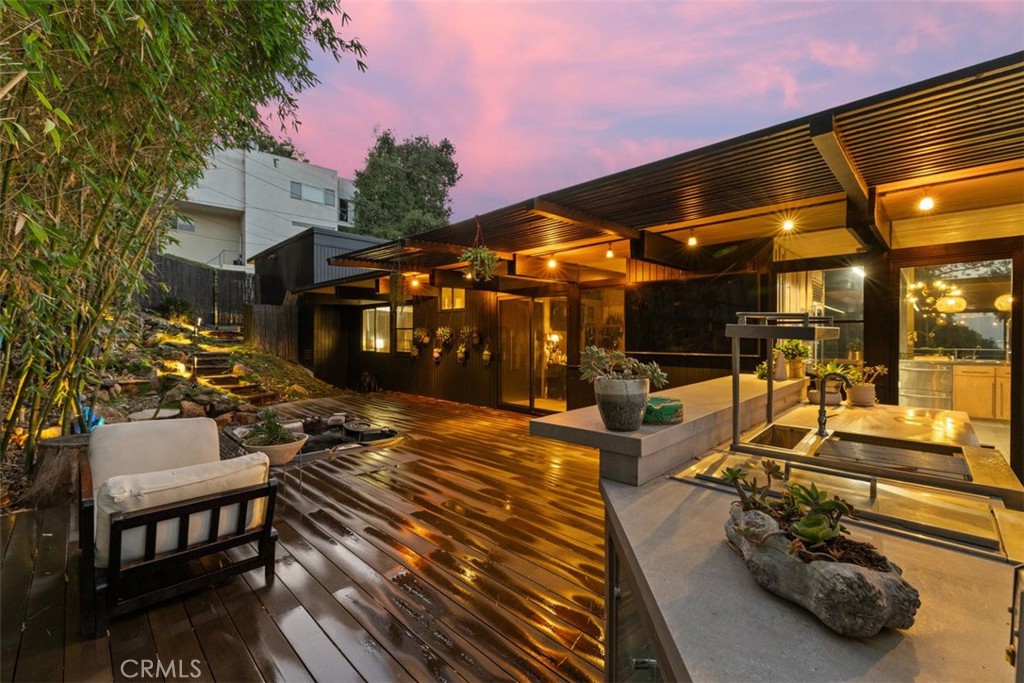 21090 Rios Street Woodland Hills, CA 91364 - Photo 58 of 61 a view of a patio with table and chairs with wooden floor and fence