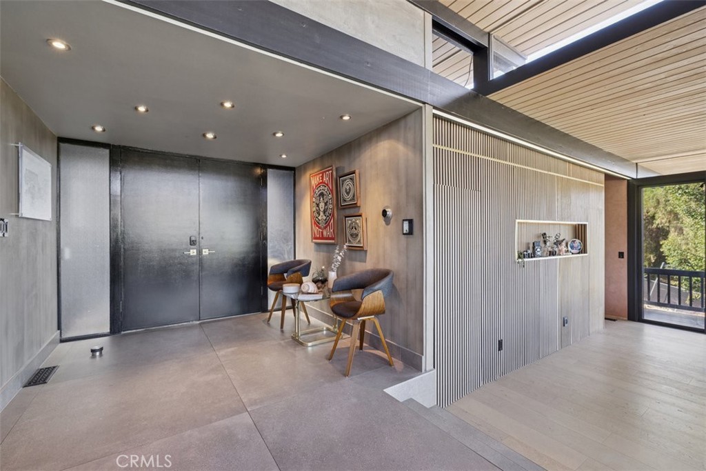21090 Rios Street Woodland Hills, CA 91364 - Photo 9 of 61 a view of a hallway with wooden furniture and windows