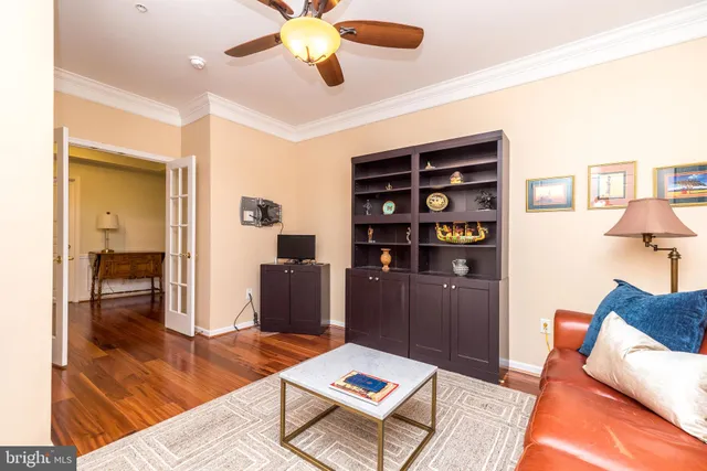 a living room with furniture and a book shelf