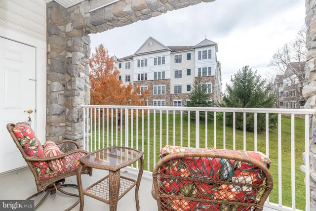 a view of a chair and table in the balcony