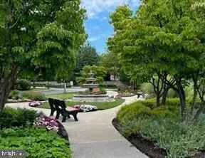 a view of swimming pool with outdoor seating and green space