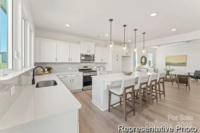 a view of kitchen with cabinets and wooden floor