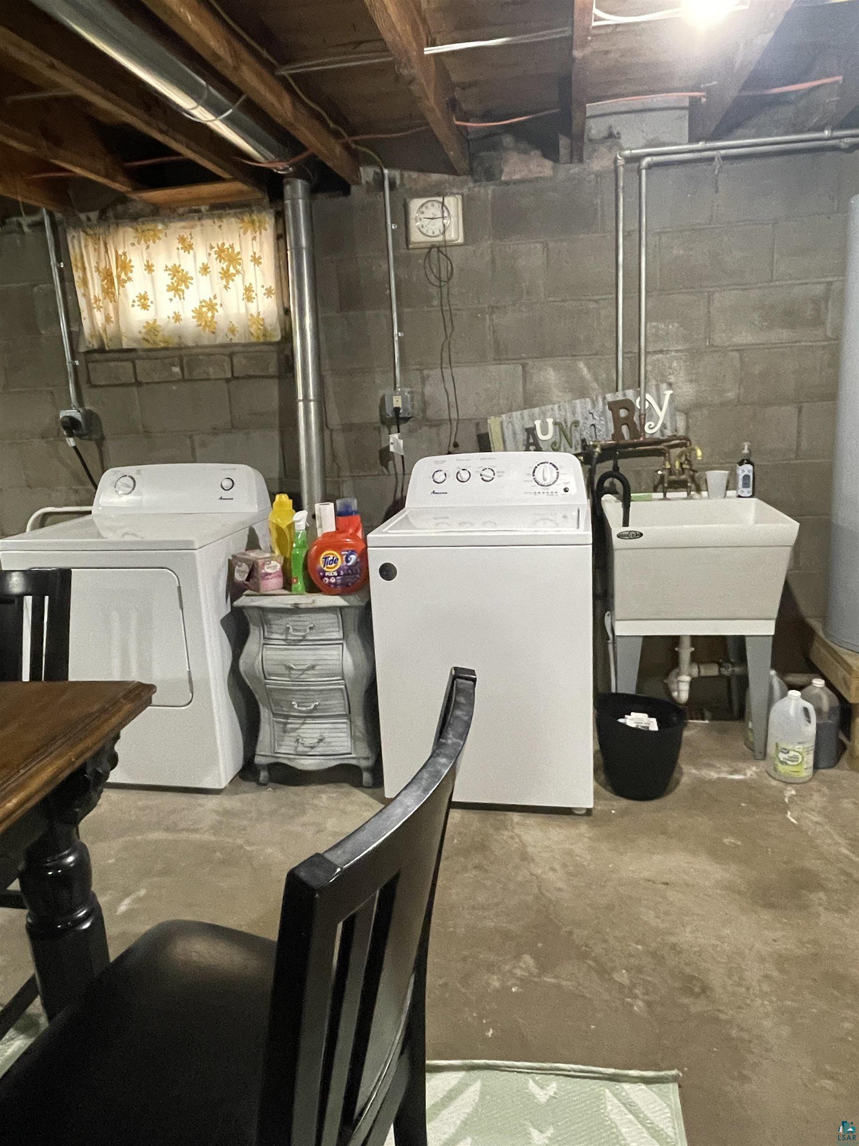 203 3rd Street South Virginia, MN 55792 - Photo 19 of 22 Laundry area featuring washing machine and dryer and concrete flooring