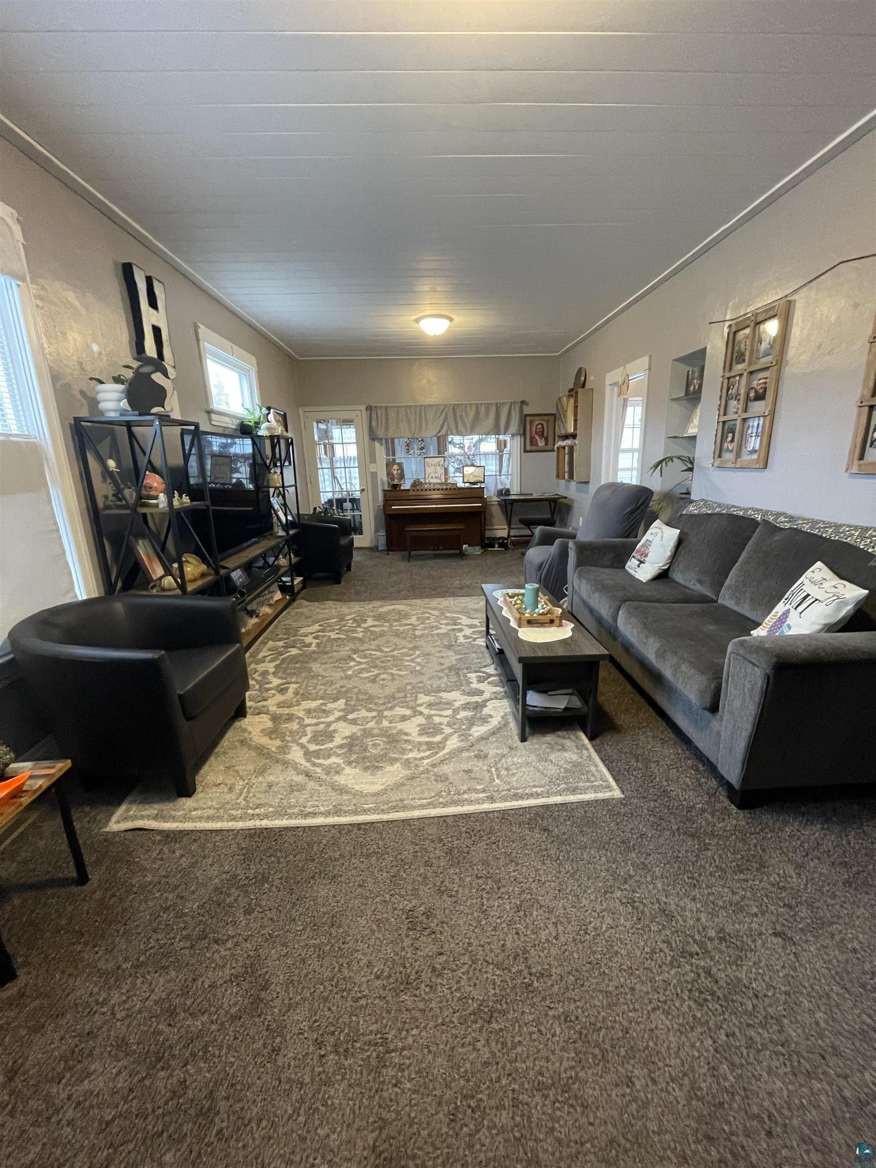 203 3rd Street South Virginia, MN 55792 - Photo 9 of 22 Carpeted living area with crown molding