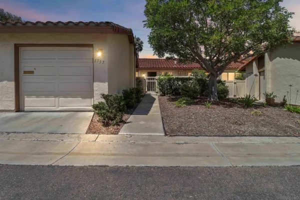 a view of a house with a yard and a garage