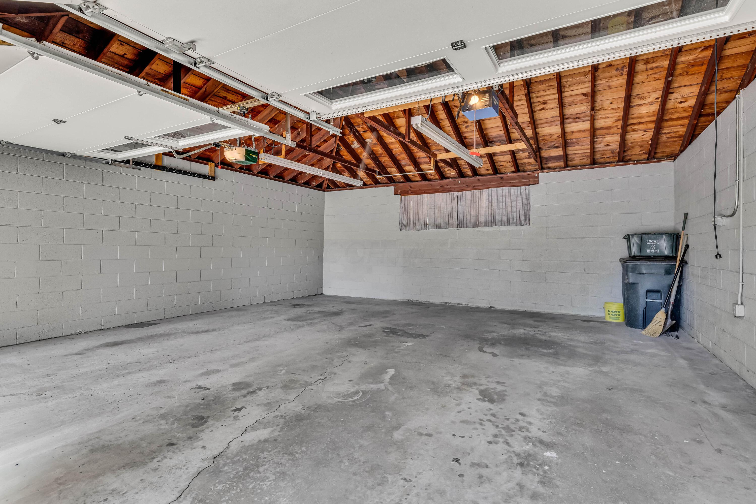 1213 East Cooke Road Columbus, OH 43224 - Photo 10 of 57 • Rear entry • Concrete flooring • Genie® electric door opener • Chamberlain® electric door opener • (2) new doors (insulated) • 220V • Block walls • Attic access • New garage doors ~ 2014/2015