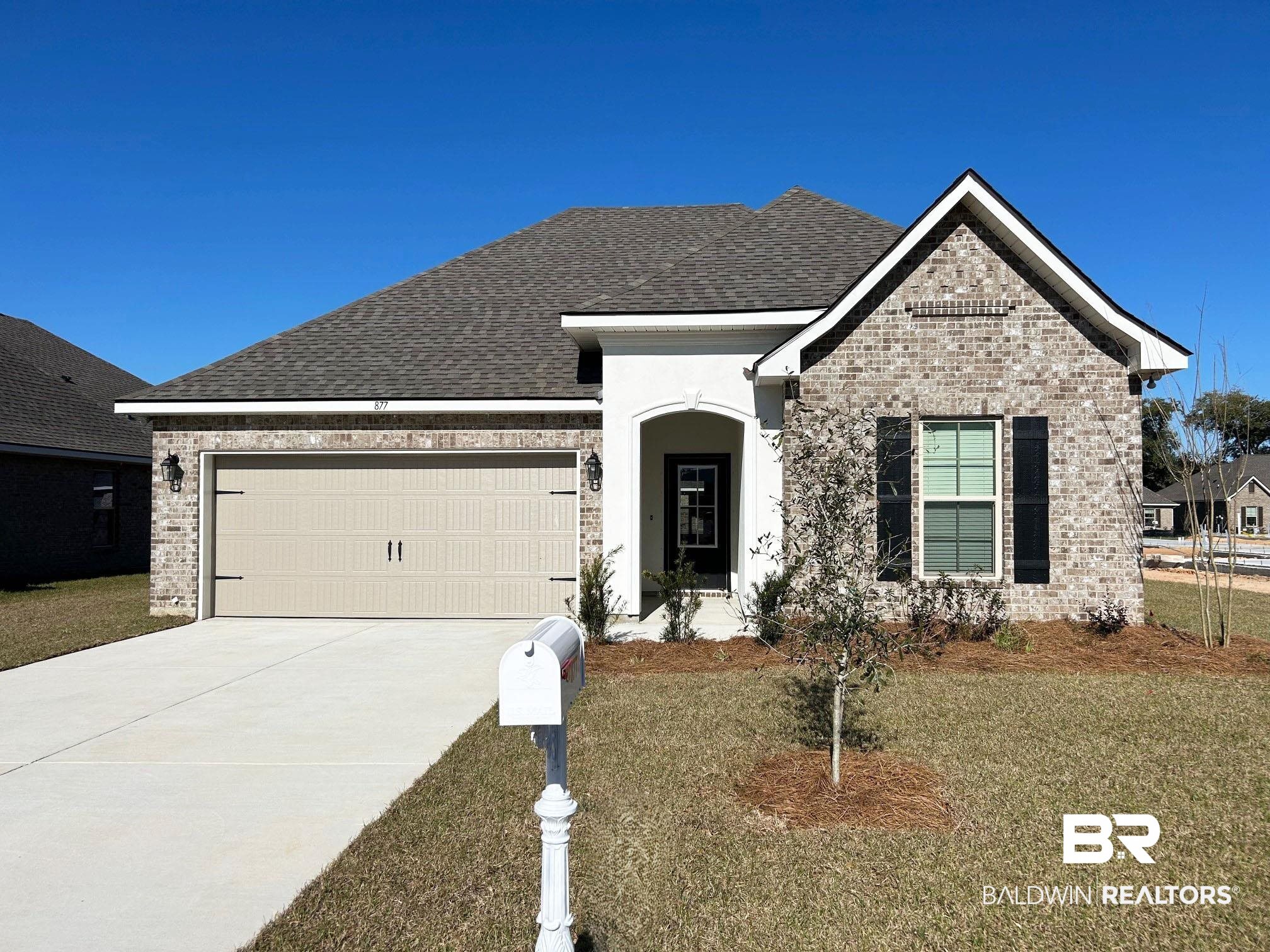877 Sumter Loop Foley, AL 36535 - Photo 1 of 18 View of front of property with brick siding, driveway, a shingled roof, and a garage